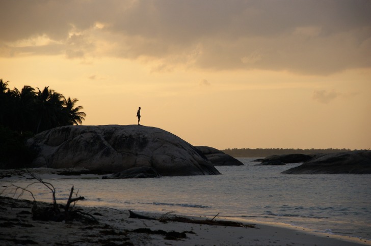 A man standing on a stone