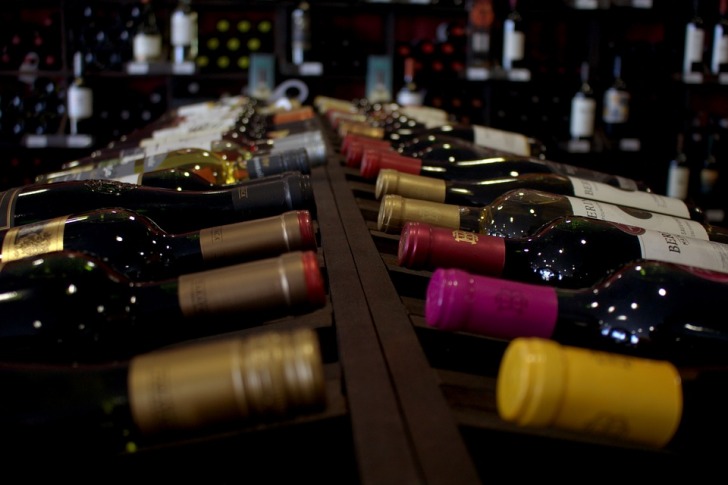 A lot of wine bottles lying on a table