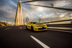 Yellow sport car with black autotuning bridge